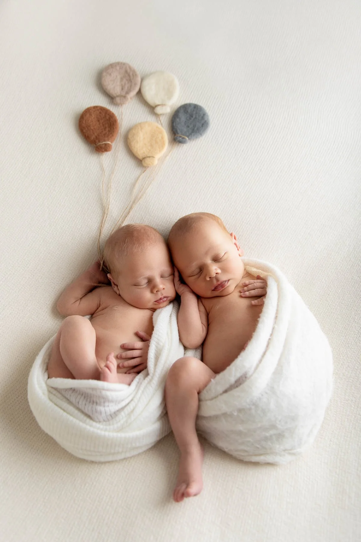 Newborn photographer Sydney North Shore
twins newborn girls laying on their tummies wearing headbands in pink tones
this award-winning photograph I did for a Family from Drummoyne.