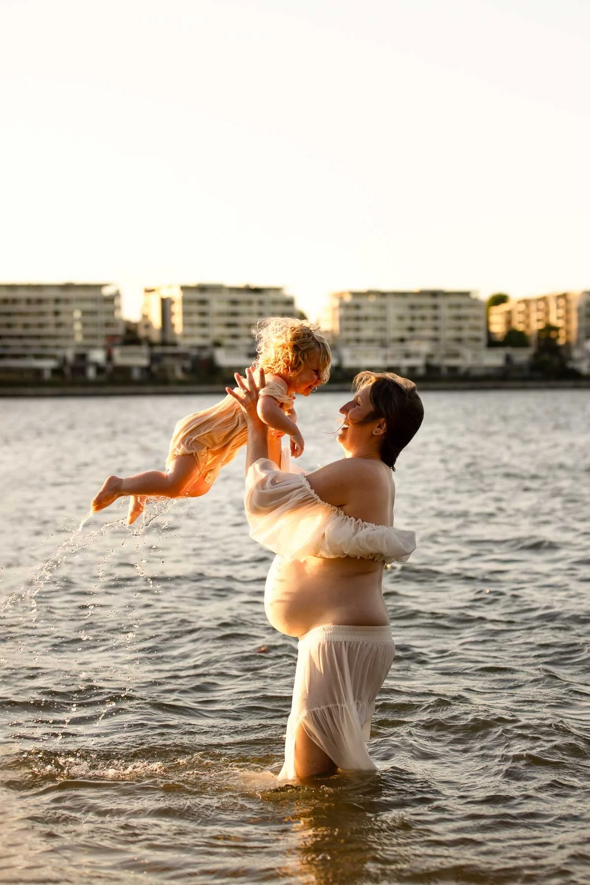 North Shore Maternity photographer, pregnant mother playing in the water with her toddler