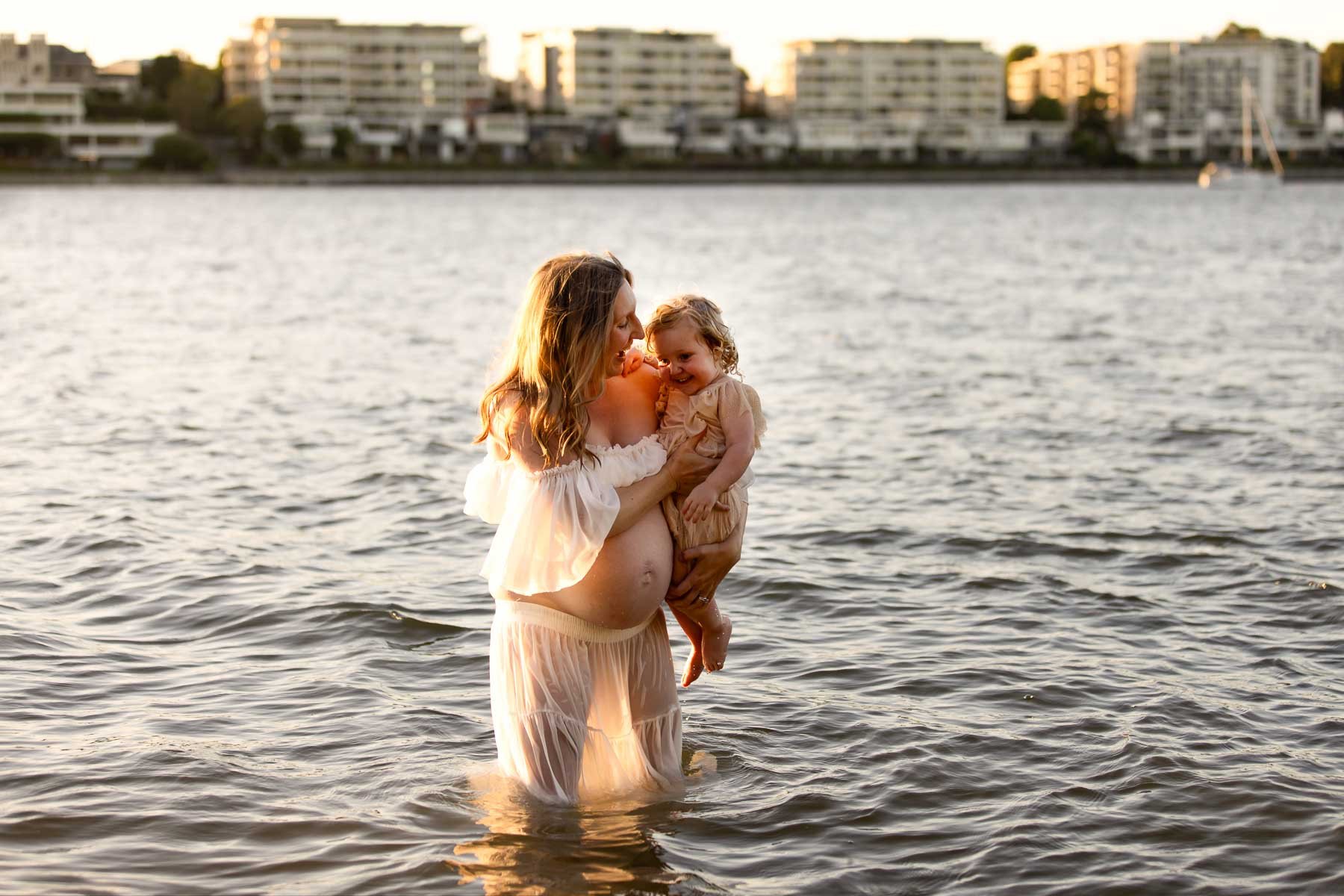 North Shore Maternity photographer, pregnant mother playing in the water with her toddler
