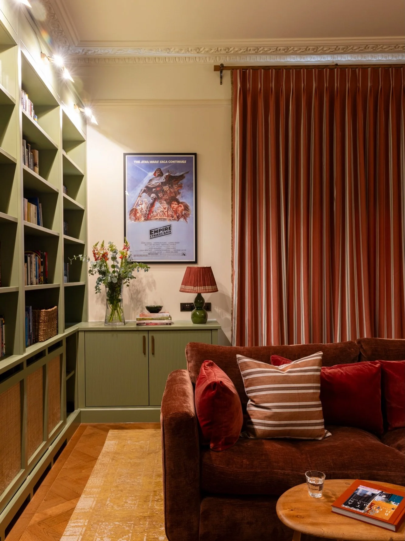 Family living room by day, home cinema by night 🎬

This room, just off the kitchen in our Chiswick project, needed to work equally well for everyday family life and cosy evenings in.

We carried the soft greens and warm terracottas through from the 