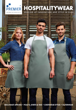 Three staff members wearing aprons, standing outdoors in front of a wooden backdrop, promoting hospitality workwear, with text about premier hospitalitywear.