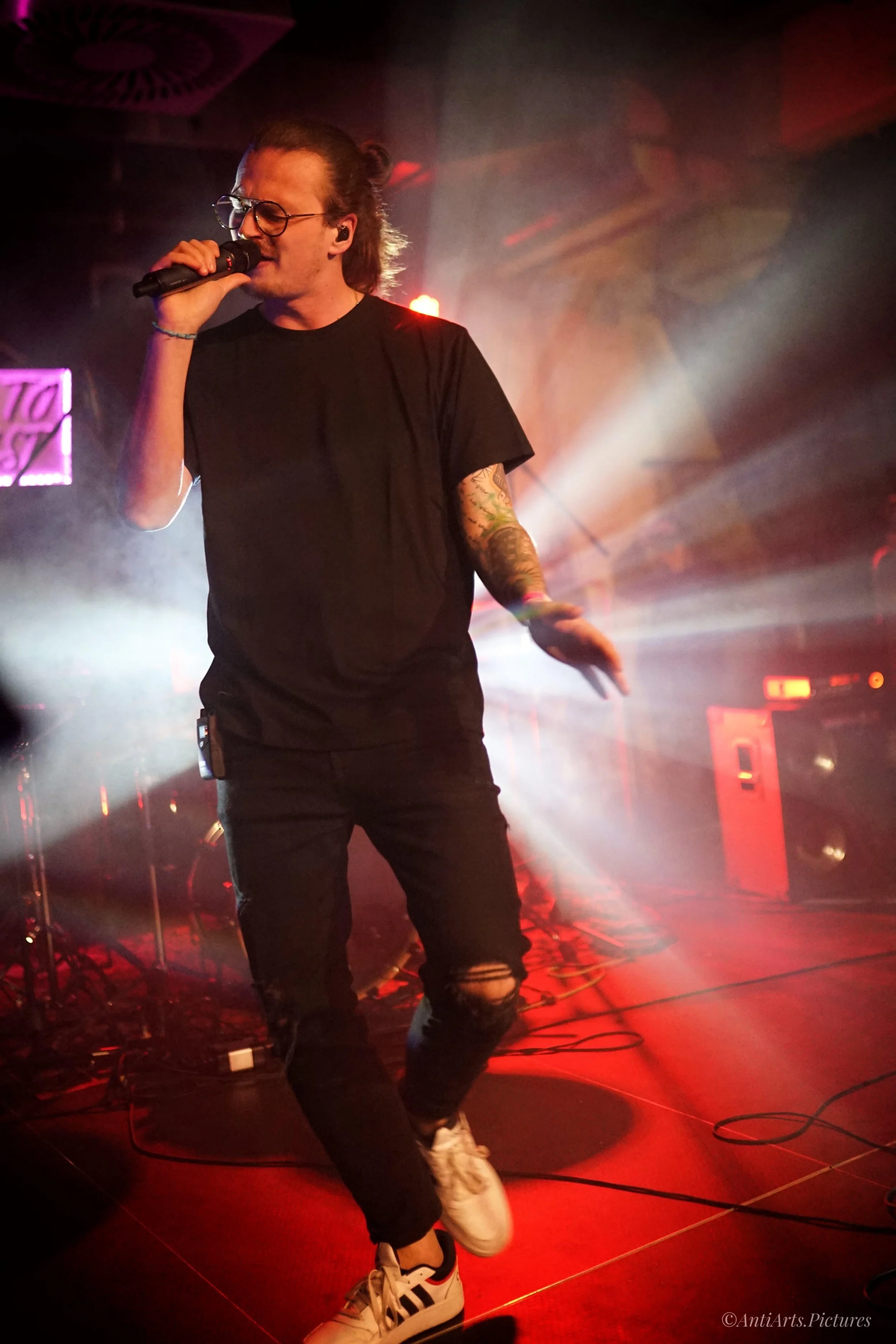 Singer with long hair on Stage with closed eyes