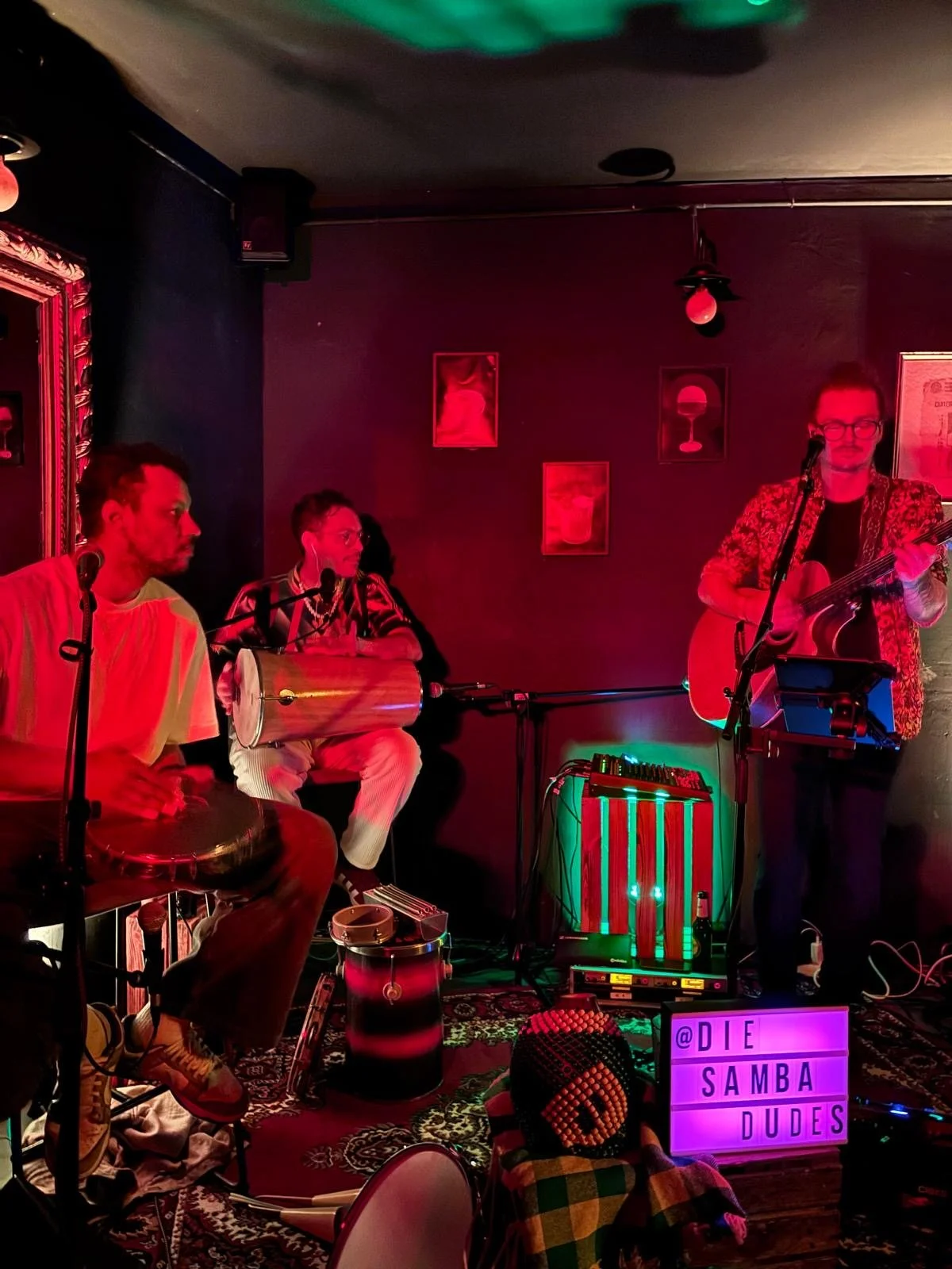 Group of 3 People makes music together live on Stage