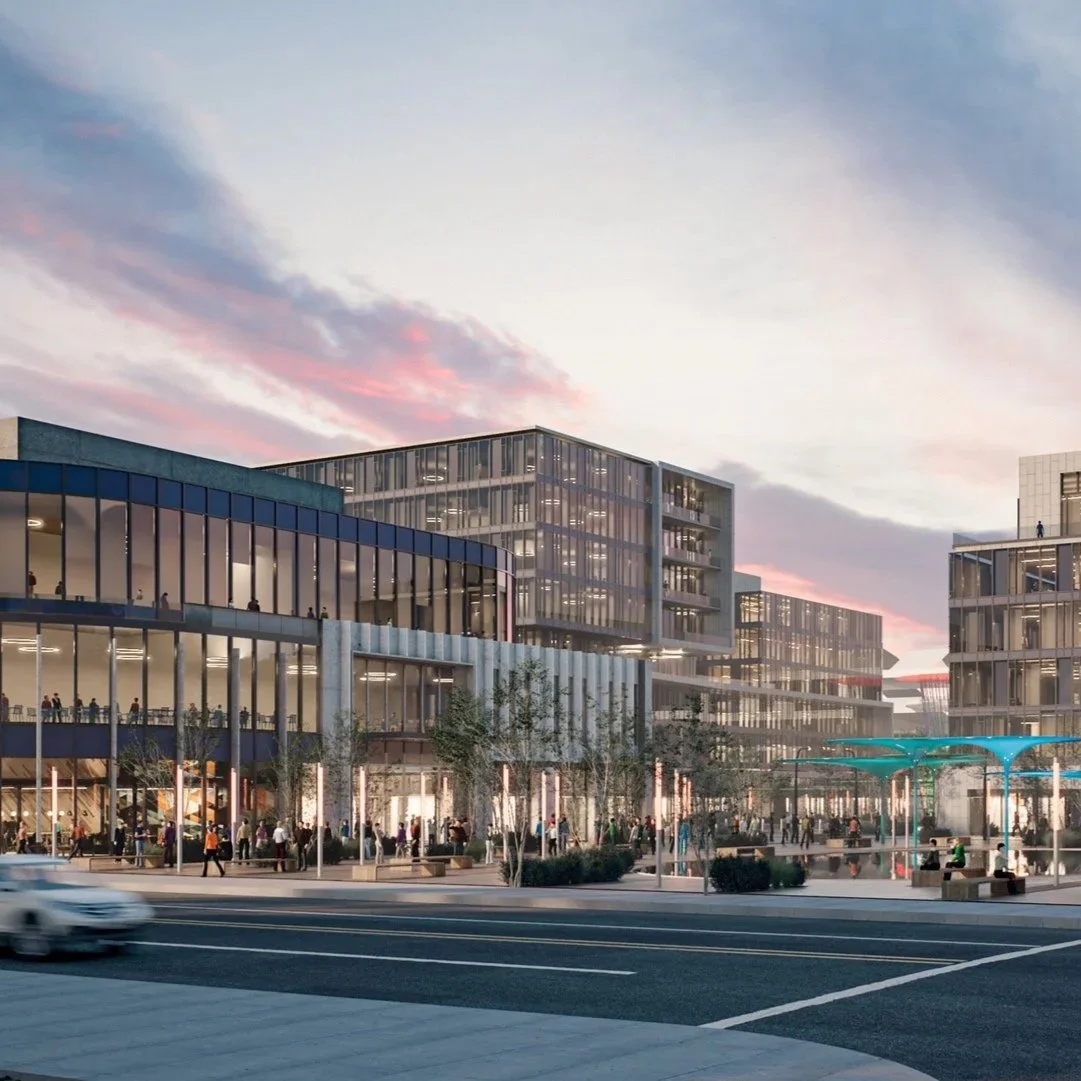 Modern mixed-use development with office and retail space, social gathering areas, and a vibrant community atmosphere under a colorful sunset sky.