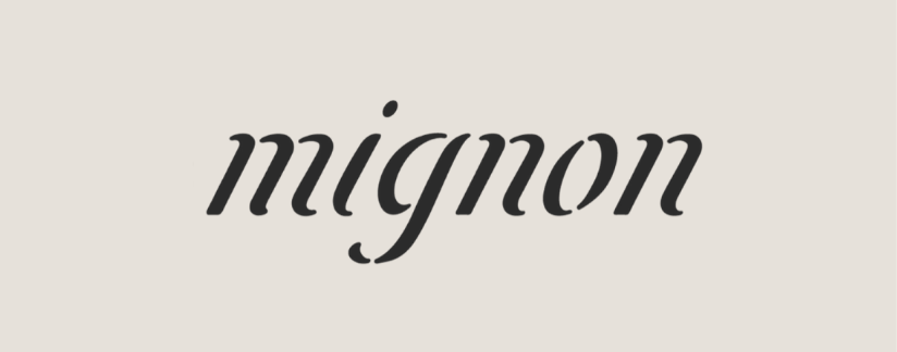Testo con la parola 'mignon' scritto in stile corsivo su sfondo chiaro.
