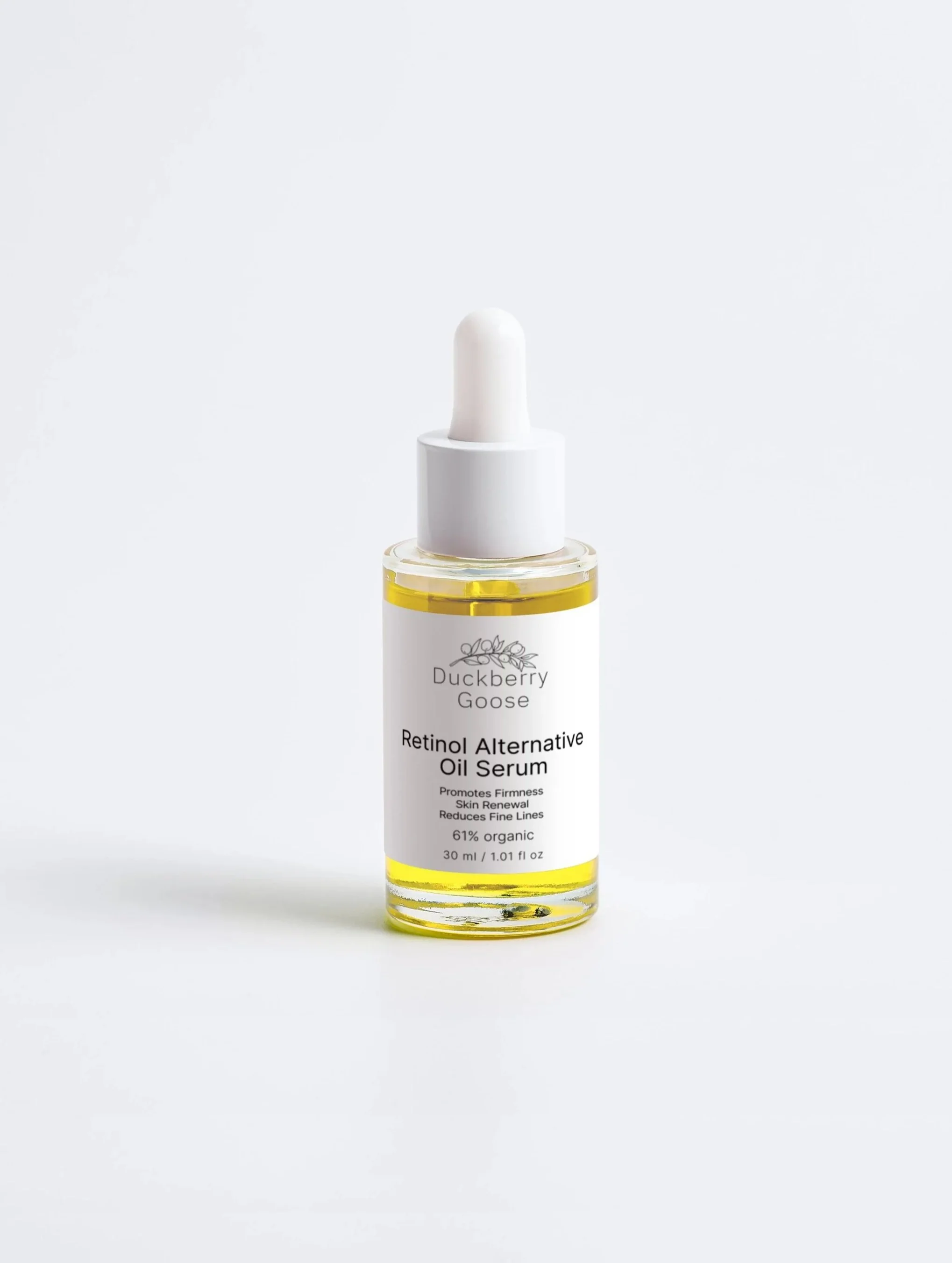 Gold serum in white bottle with white box next to it showing Duckberry Goose's Retinol Alternative Oil Serum for face