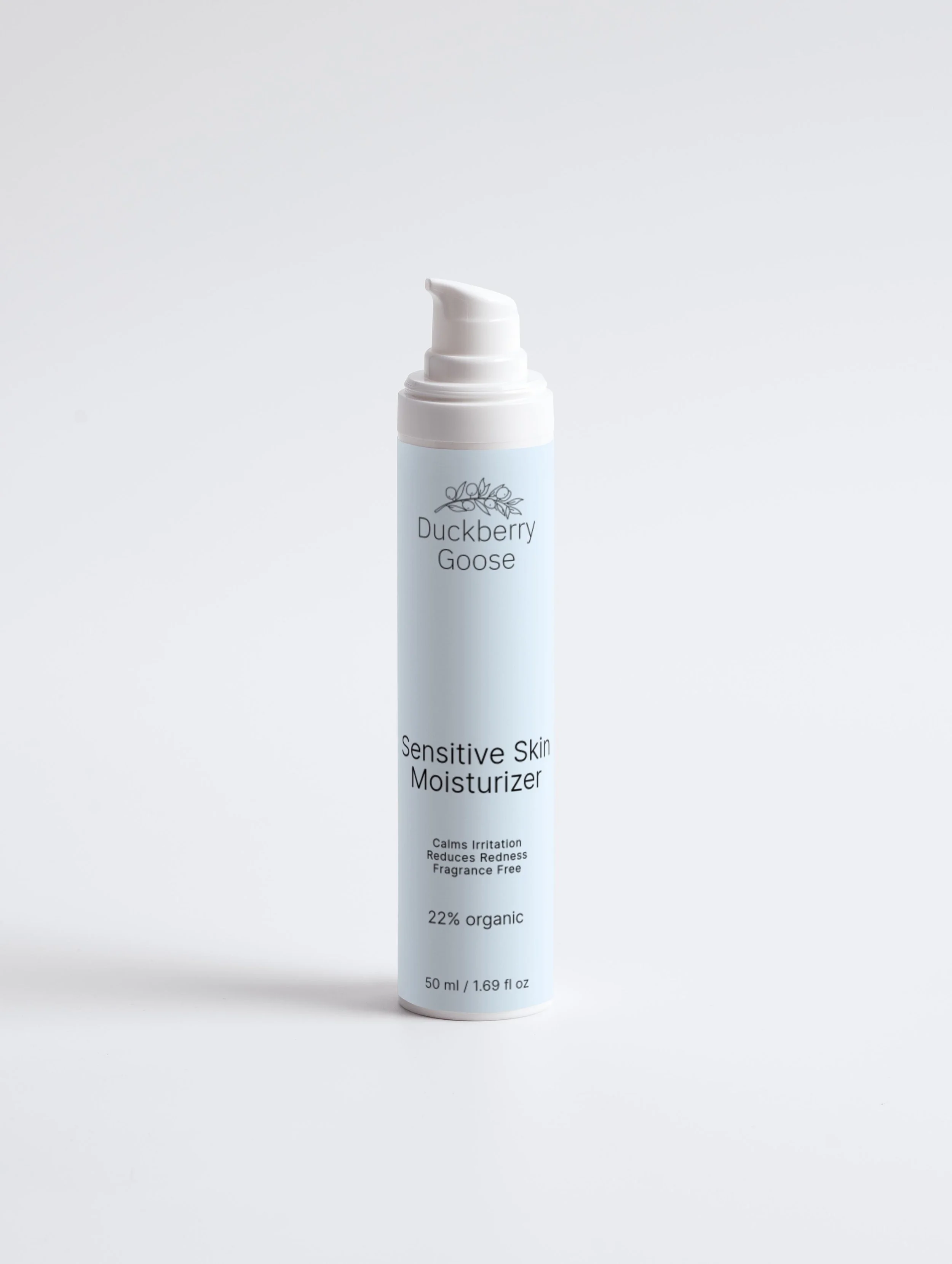Light blue bottle of Duckberry Goose Sensitive Skin Moisturizer with pump dispenser next to its box, which displays product details and branding.'
