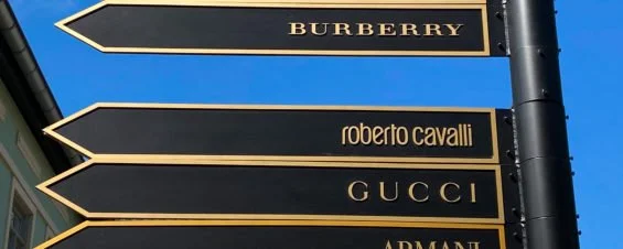 Directional Sign with Luxury Brand Names