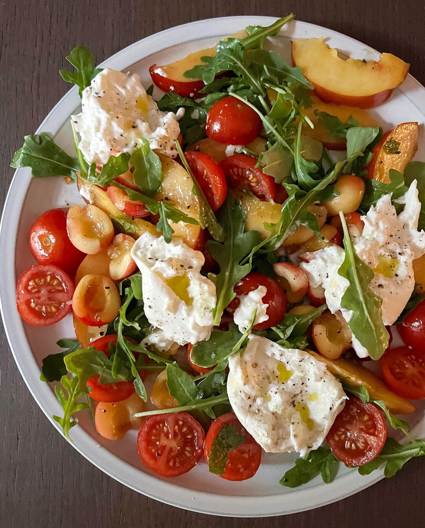 Again and again and again: stone fruit, tomatoes, handful of greens, herbs, burrata. Splash of olive oil and good vinegar, s&amp;p. Summer at its best. #summereating #summersalad #stonefruit #salad #burrata