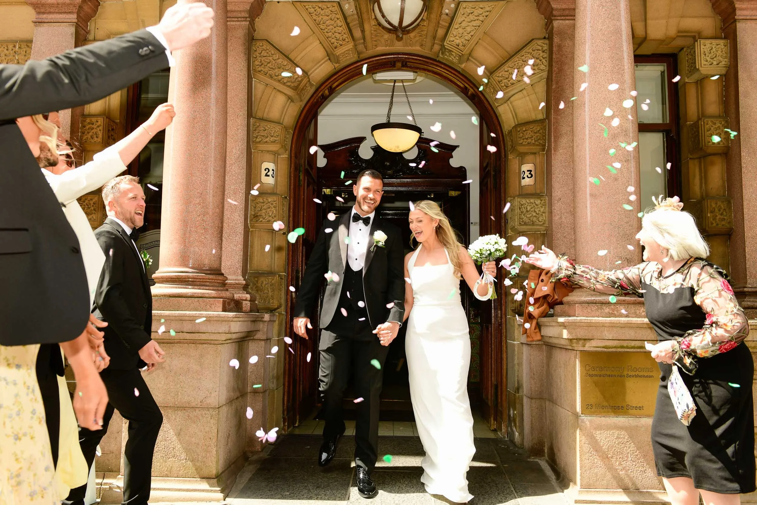 Glasgow City centre registry wedding at 23 Montrose Street with confetti for the bride and groom as they step outside for the first time as a married couple.