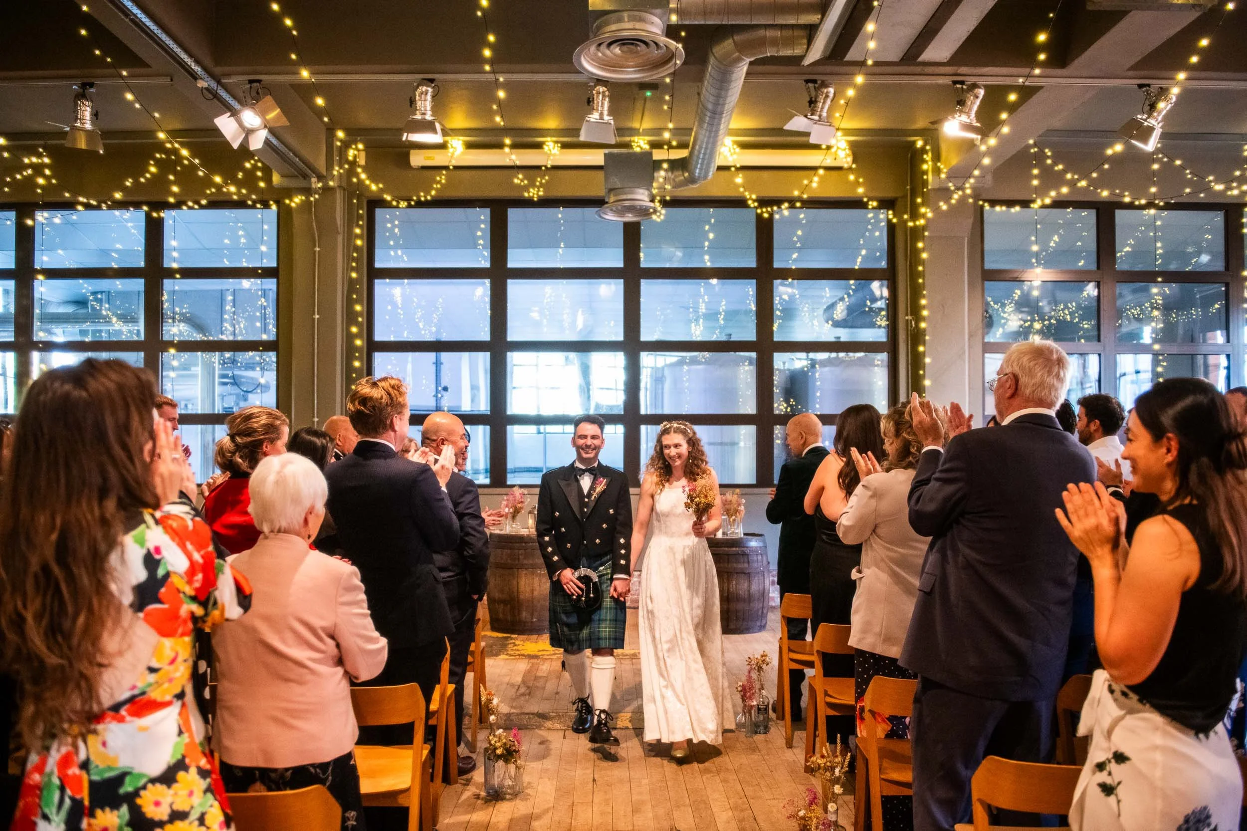 Glasgow wedding photography at West on The Green with the newlyweds walking up the aisle.