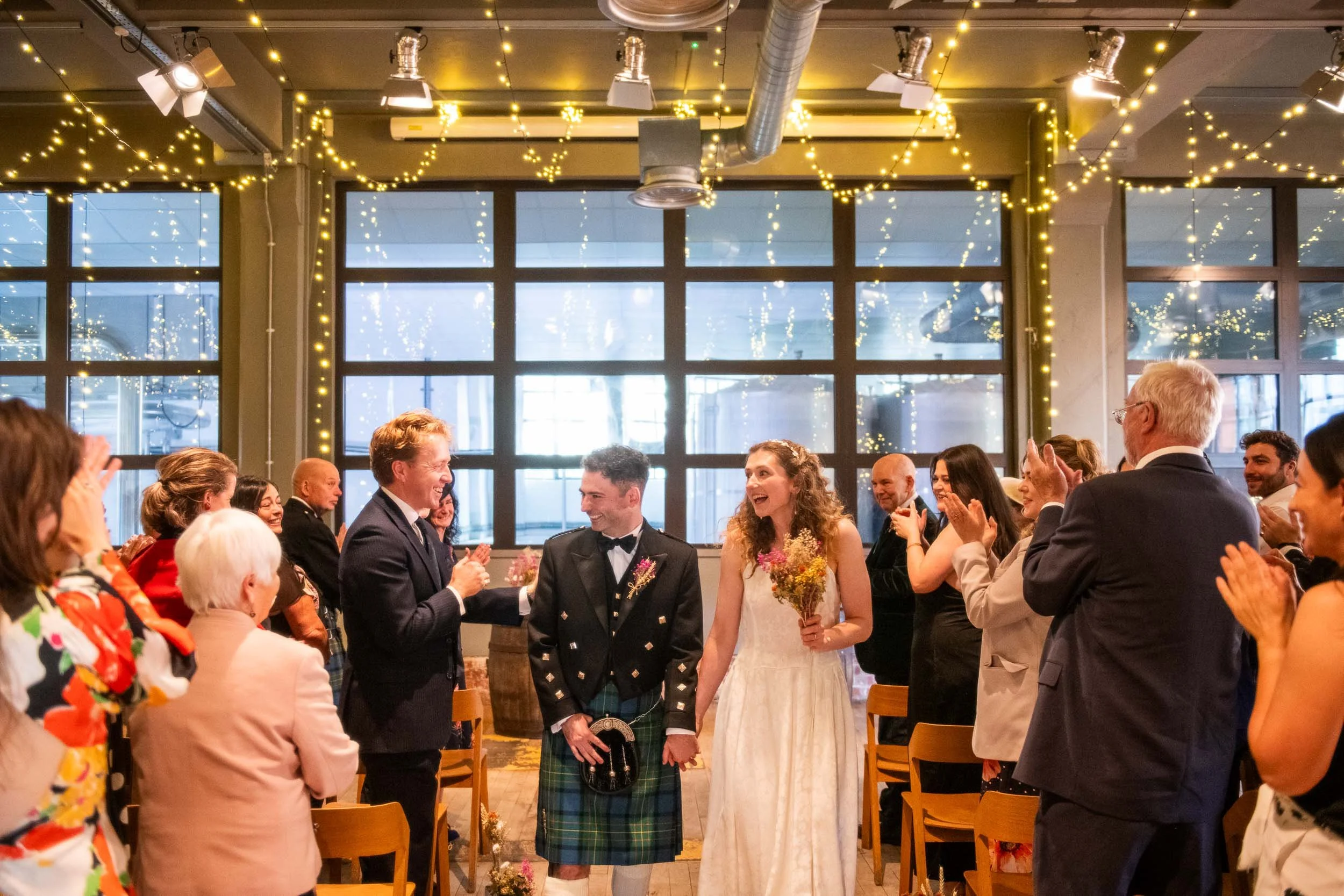 Glasgow wedding photography at West on The Green with the bride and groom walking up the aisle.
