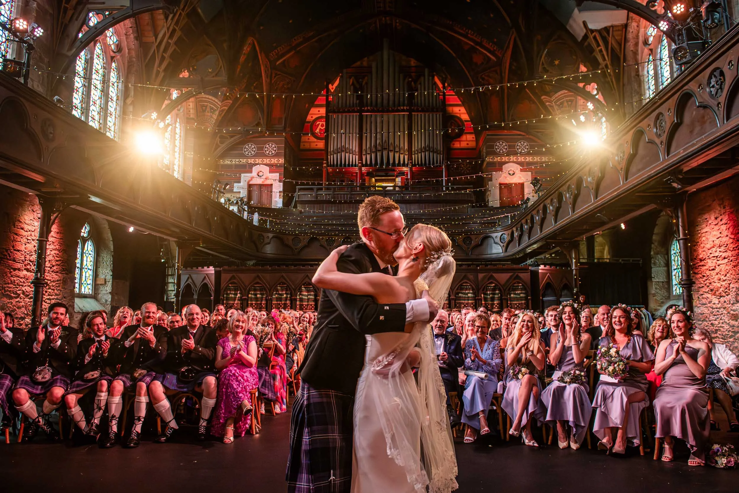 Glasgow wedding with the bride and groom sealing their vows with a kiss in the west end venue of Cottiers.