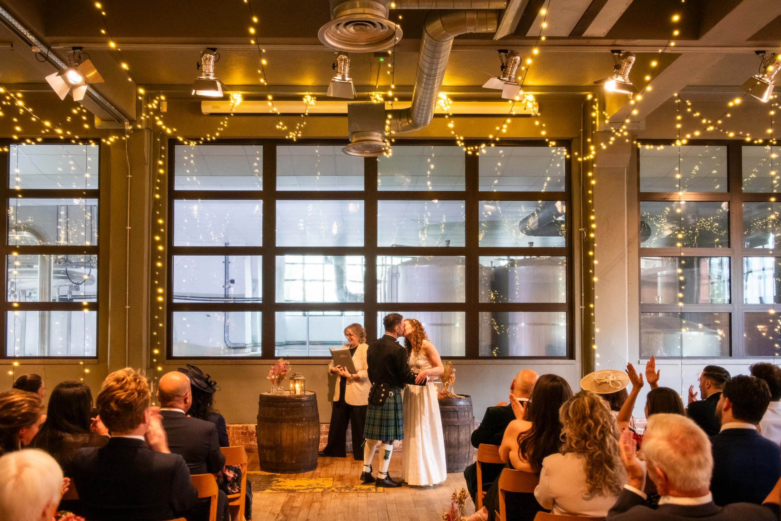 Glasgow wedding with the newlyweds sealing their vows with a kiss at West on The Green.