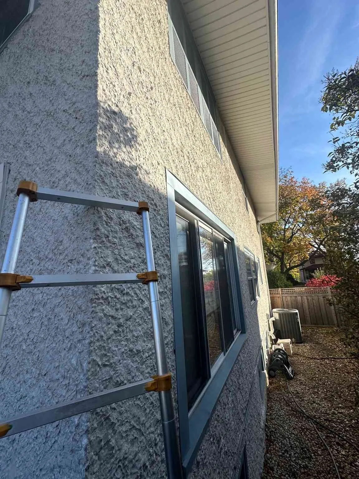 Asbestos testing on exterior stucco wall of a residential home in Oak Park IL