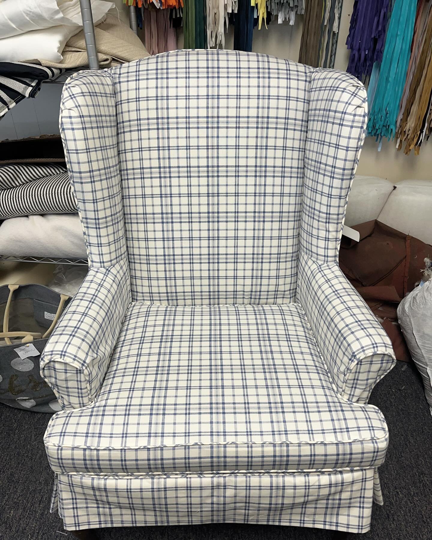 A new blue and white plaid slipcover for this vintage wingback. We were working with minimal fabric on this one but made it happen - pattern matching and all! Fun fact: the matching ottoman and chair welting are made of a matching tablecloth. 
&bull;