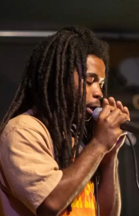 An artist performing with a microphone