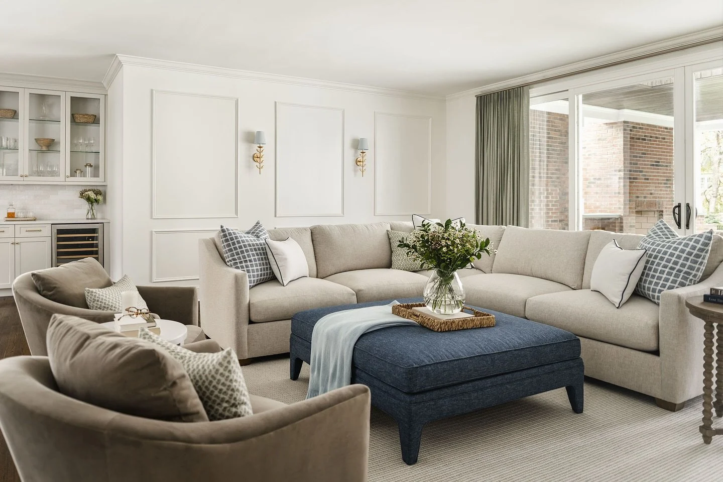 One of our favorite features of the updated family room is the addition of the 16-foot sliding glass doors, which floods the space with natural light.

To balance openness with privacy, we installed custom green traversing drapery, making it easy to 