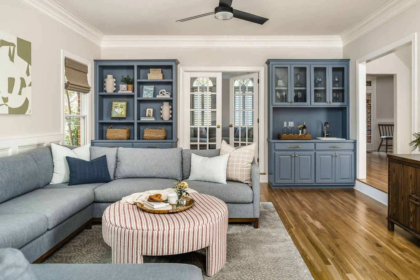 Another feature I love about our family room is the original built-ins. 

Rather than replacing them, I wanted to preserve the character. We had them refinished in a soft blue and updated the hardware with timeless brass. I also refreshed the wet bar