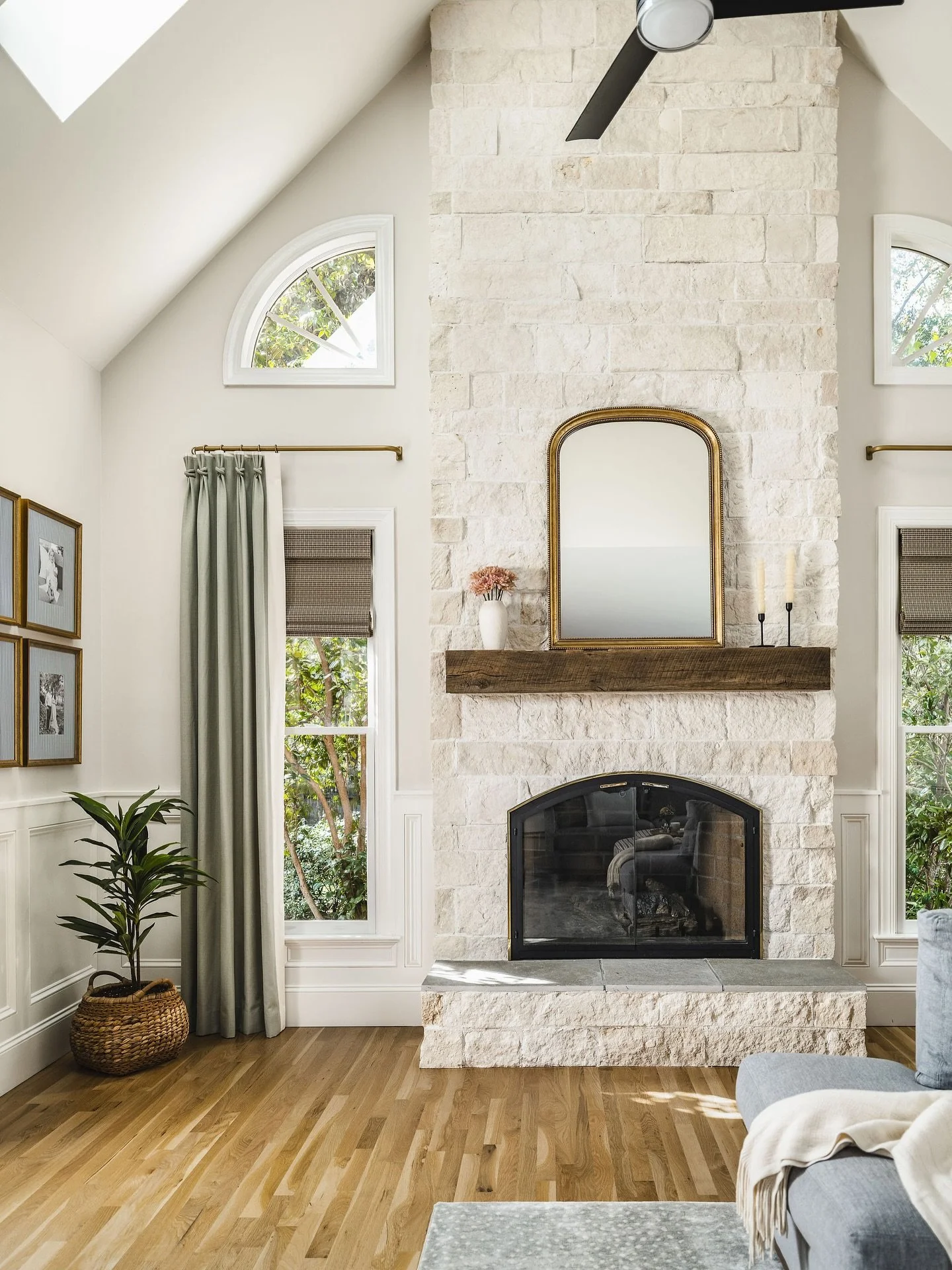 Design is in the details, and a few of my favorites live right in this corner. In my opinion, window treatments are what pull a room together. I love to layer them, as I did here with drapery panels over woven Roman shades, and added this fun crisscr