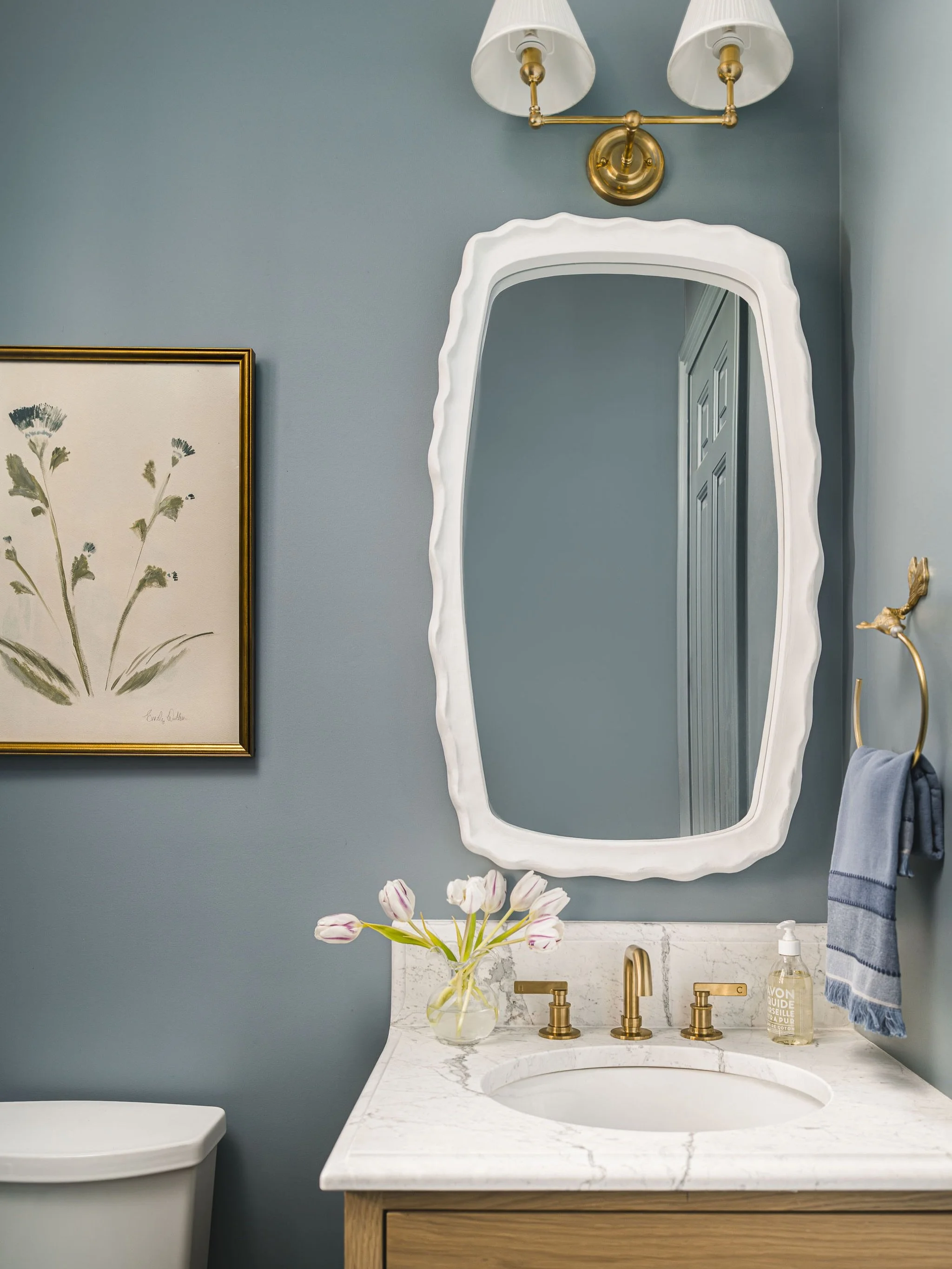 Blue is always a good idea, especially in a color drenched powder room. 

The original space had a busy wallpaper, so we knew we wanted to bring drama in a different way. Painting the entire room from floor to ceiling the same shade did the trick.

O