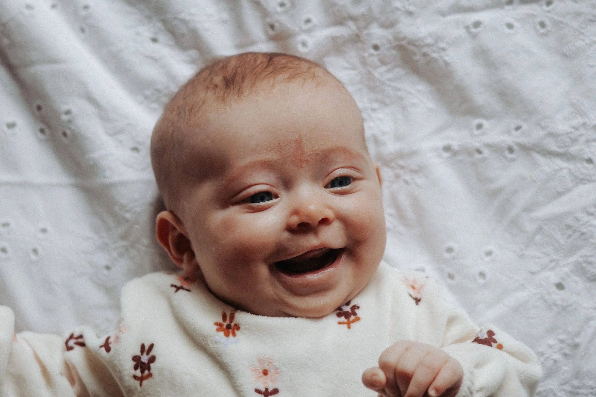 photo of baby smiling Lifestyle newborn family photography in uxbridge ontario