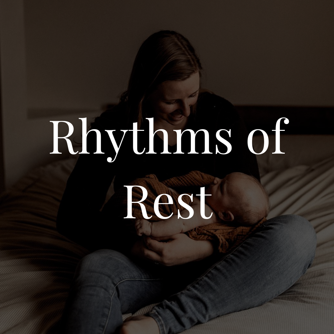 A woman sitting on a bed holding a baby, both smiling and looking at each other, with the text "Rhythms of Rest" overlaid on the image.