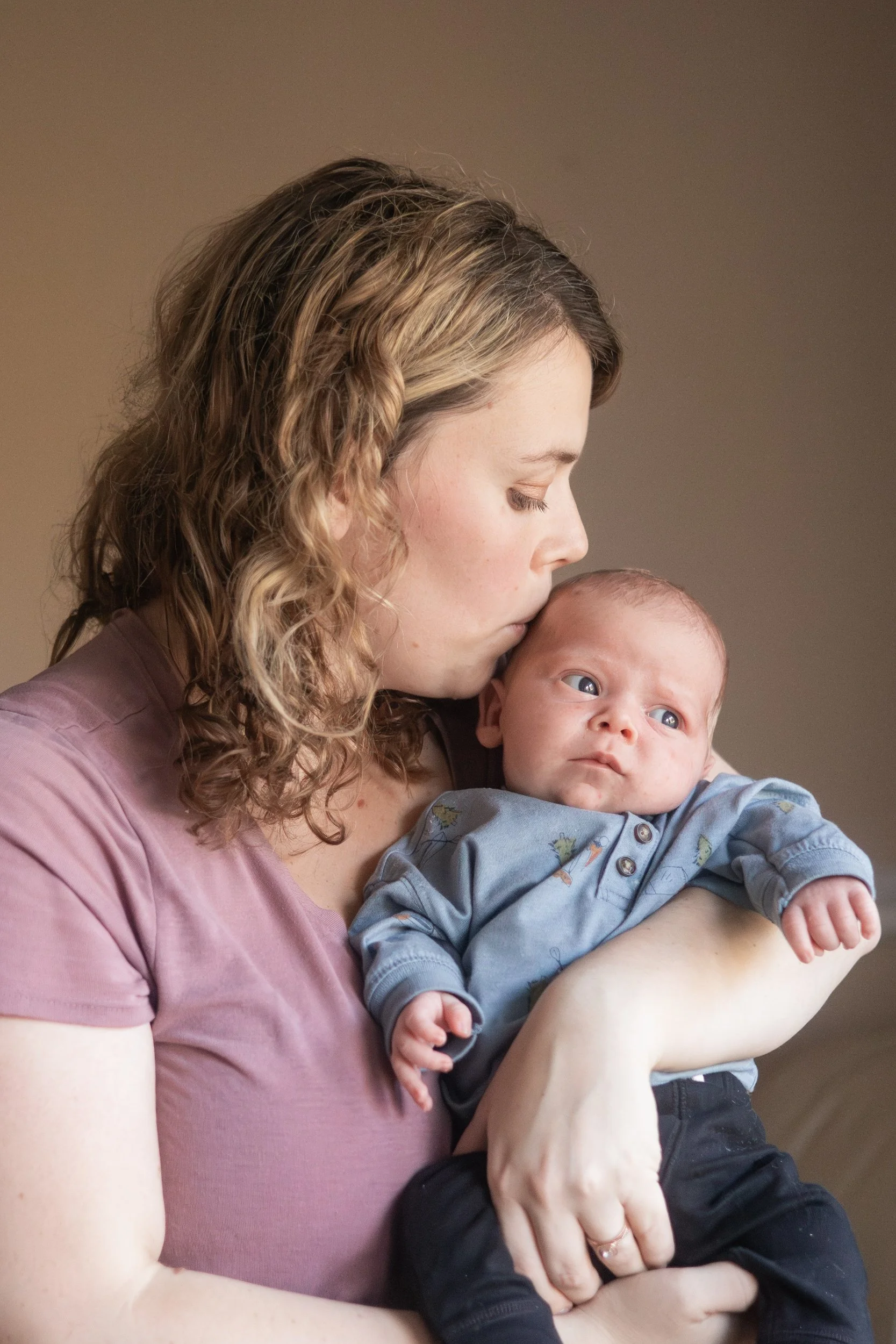 mom kissing baby Lifestyle newborn family photography in uxbridge ontario