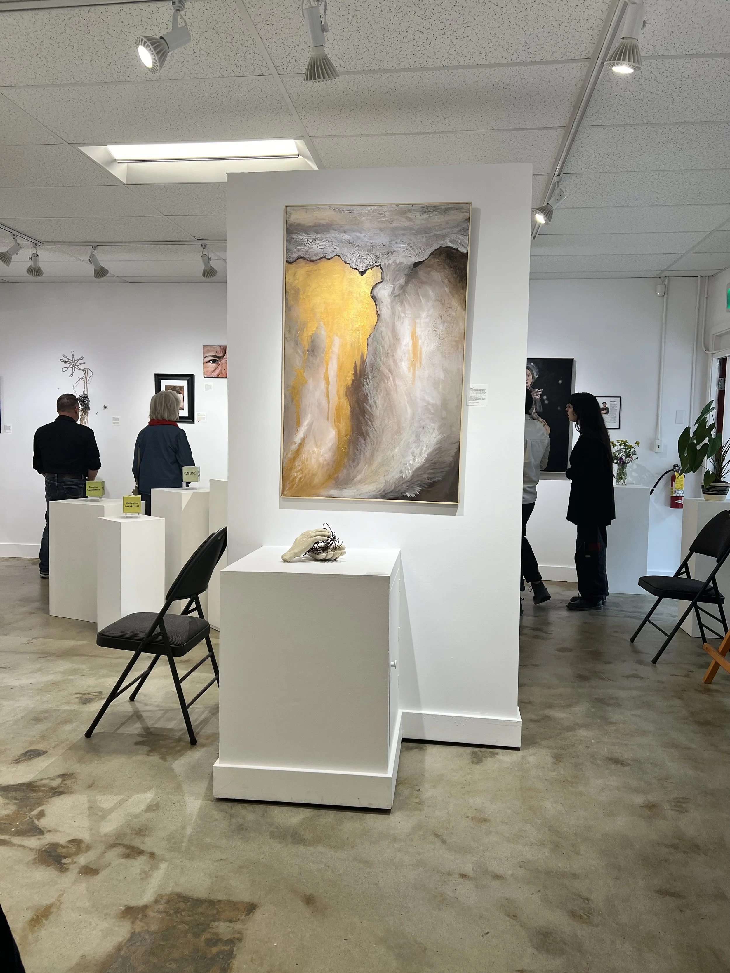 "Ruptured” on display at Metchosin ArtPod Gallery, juried into the group exhibition Pieces of Me. This photo captures visitors gathered around Mara Szyp’s striking abstract painting, admiring its dynamic textures and earthy tones.