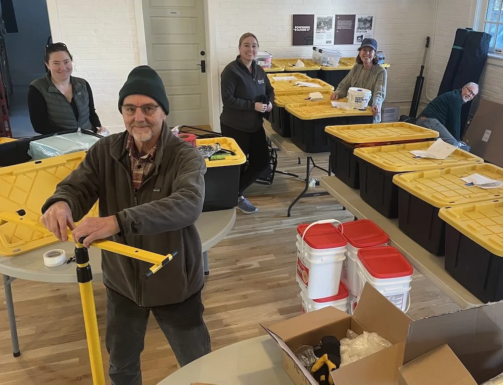 The volunteer Contents Crew filling up tubs with supplies