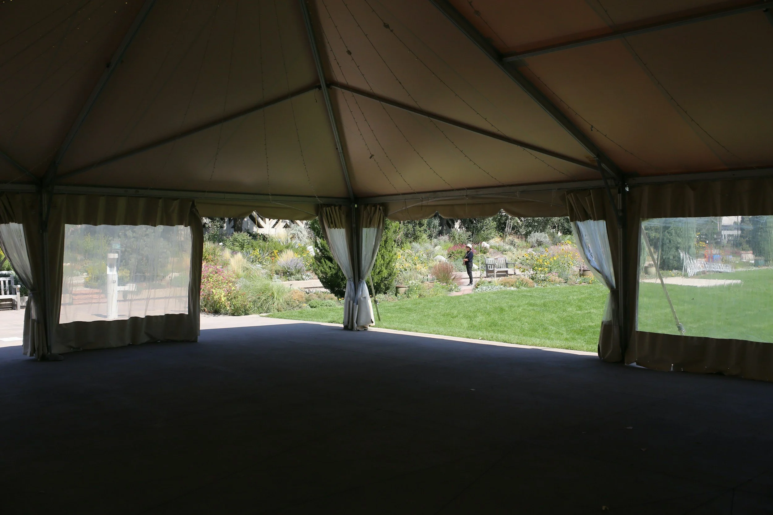 A view to the exterior from inside a large tent