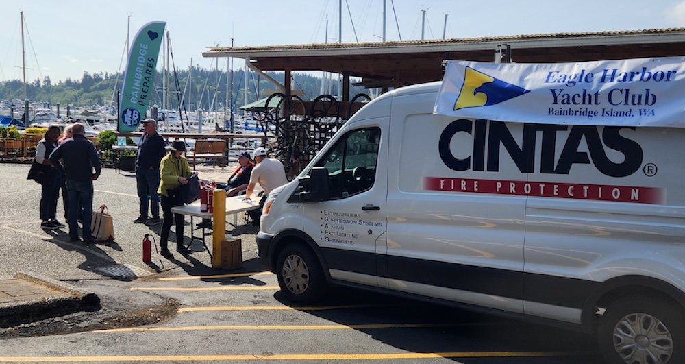 The Cintas van at the fire extinguisher event with attendees talking