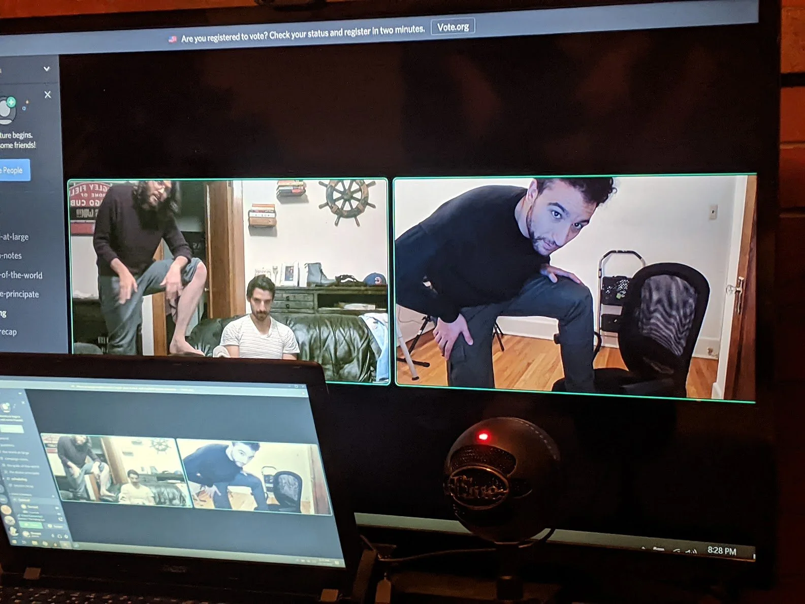  A computer screen showing a video call of Andrew with one leg on a couch, one leg of his jeans are rolled up. next to him, another player mirrors the same pose 