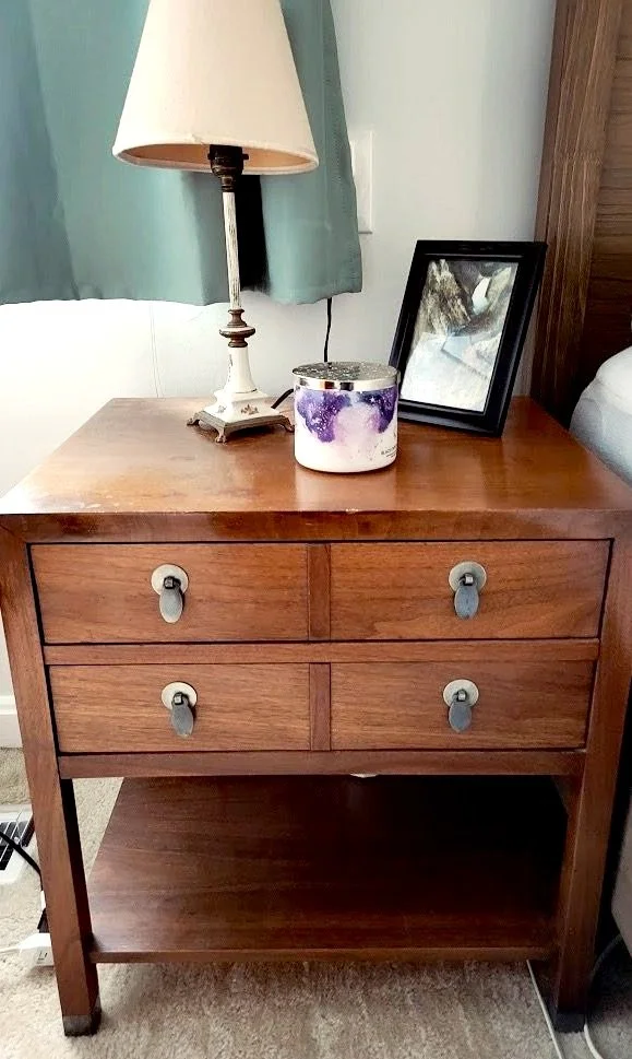 Bed side table with small lamp and photo on top