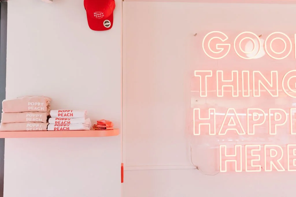 Display of folded white and pink towels with 