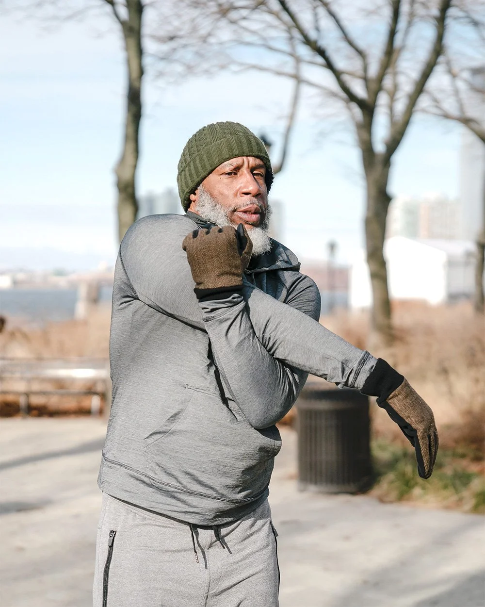 Older black man stretching outside before a workout