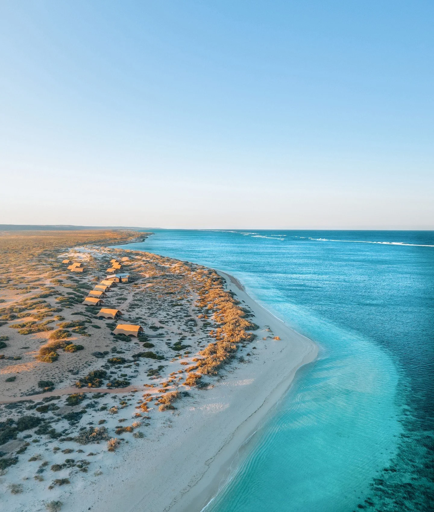 Where the reef meets the range.

From above, the beauty of Cape Range National Park reveals itself in layers &mdash; rust-red earth, turquoise shallows and the untouched stretch of coastline along Ningaloo Reef.

Tucked lightly into the dunes, Sal Sa