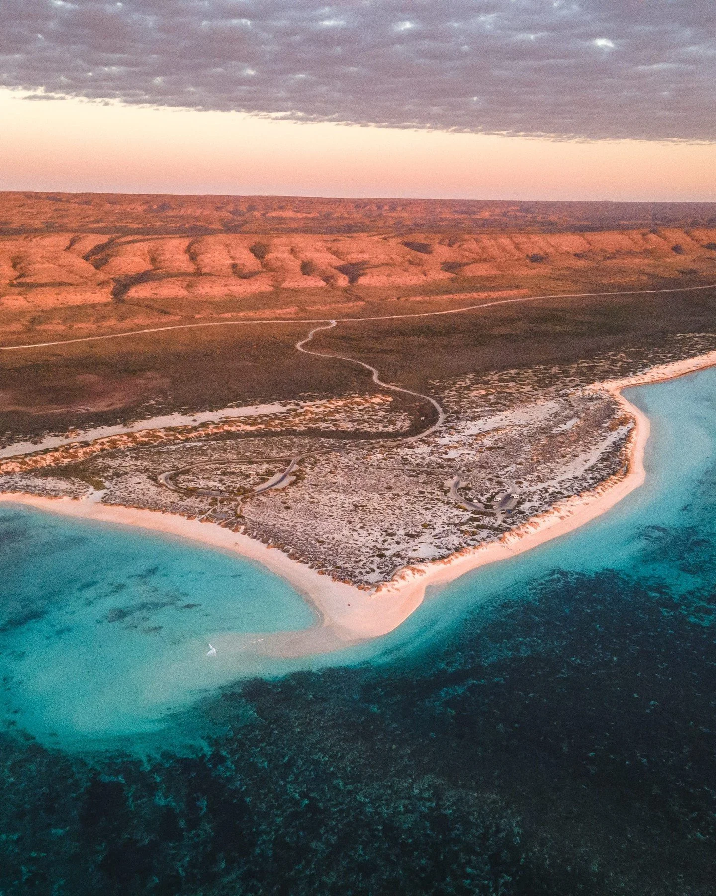 At Turquoise Bay, Western Australia, the water shifts through endless shades of blue, so clear you can see the reef just beneath the surface. Fringed by white sand and untouched coastline, it is one of those places that feels as good as it looks.

St