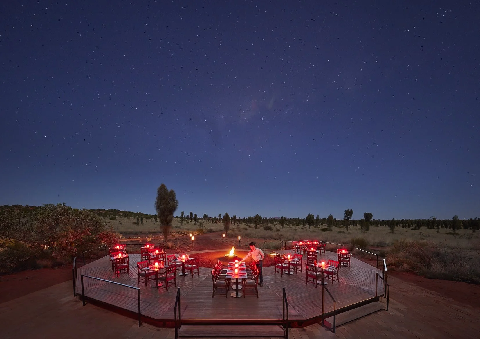 A private dining setup under the stars at Longitude 131 resort in Uluru, Australia, with a guided astronomy lesson enhancing the luxury outback experience.