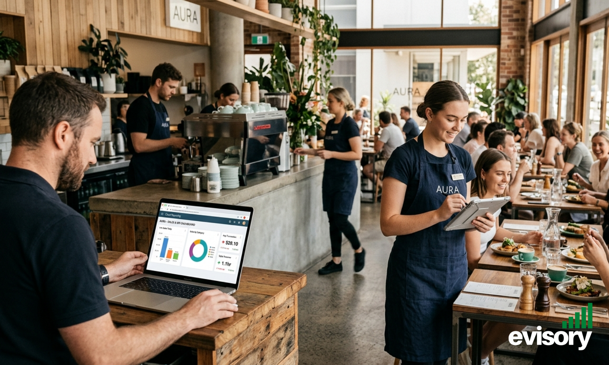 Cafe staff working in a cafe. The owner is looking at the cafe's financial status in a laptop