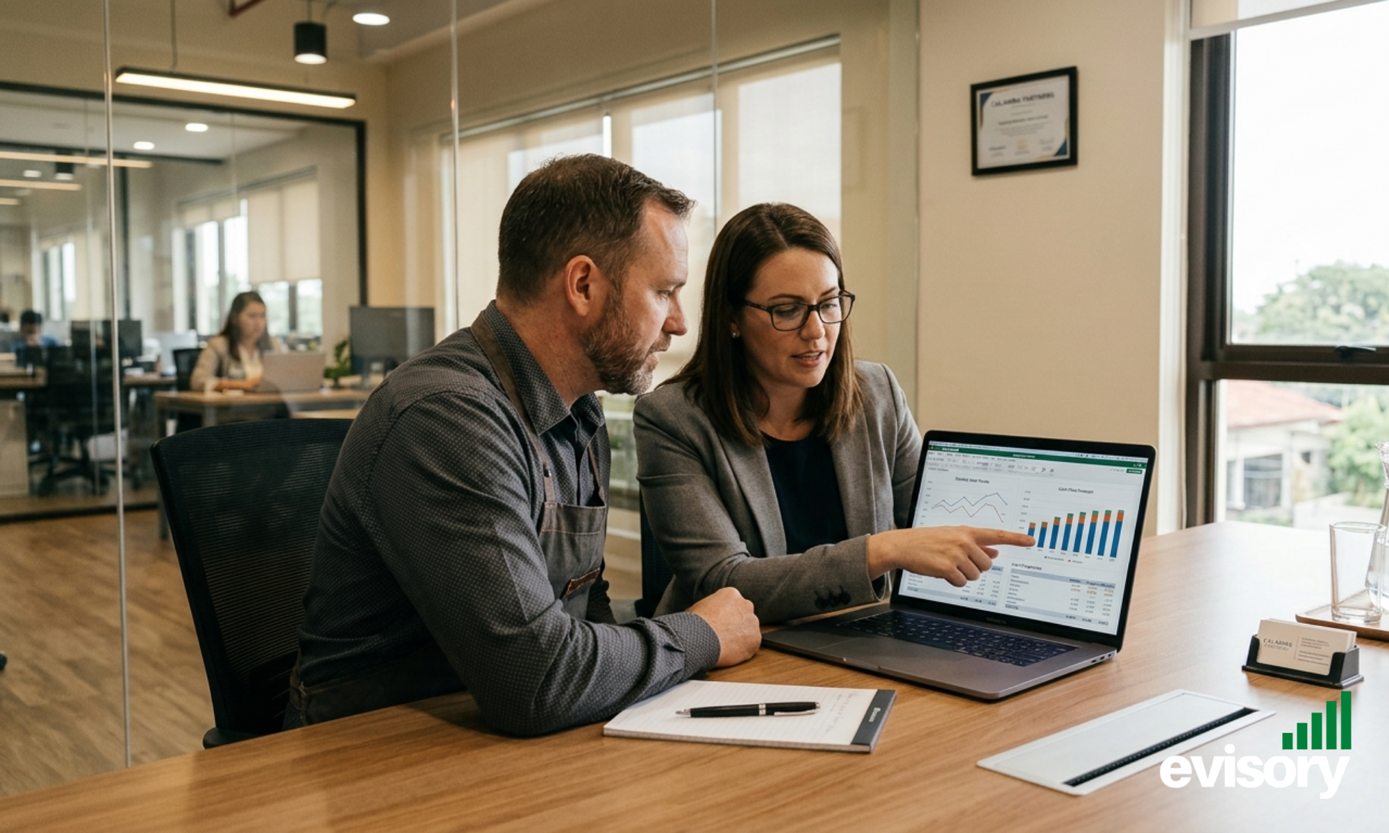 Hospitality business owner reviewing cash flow forecast with financial consultant