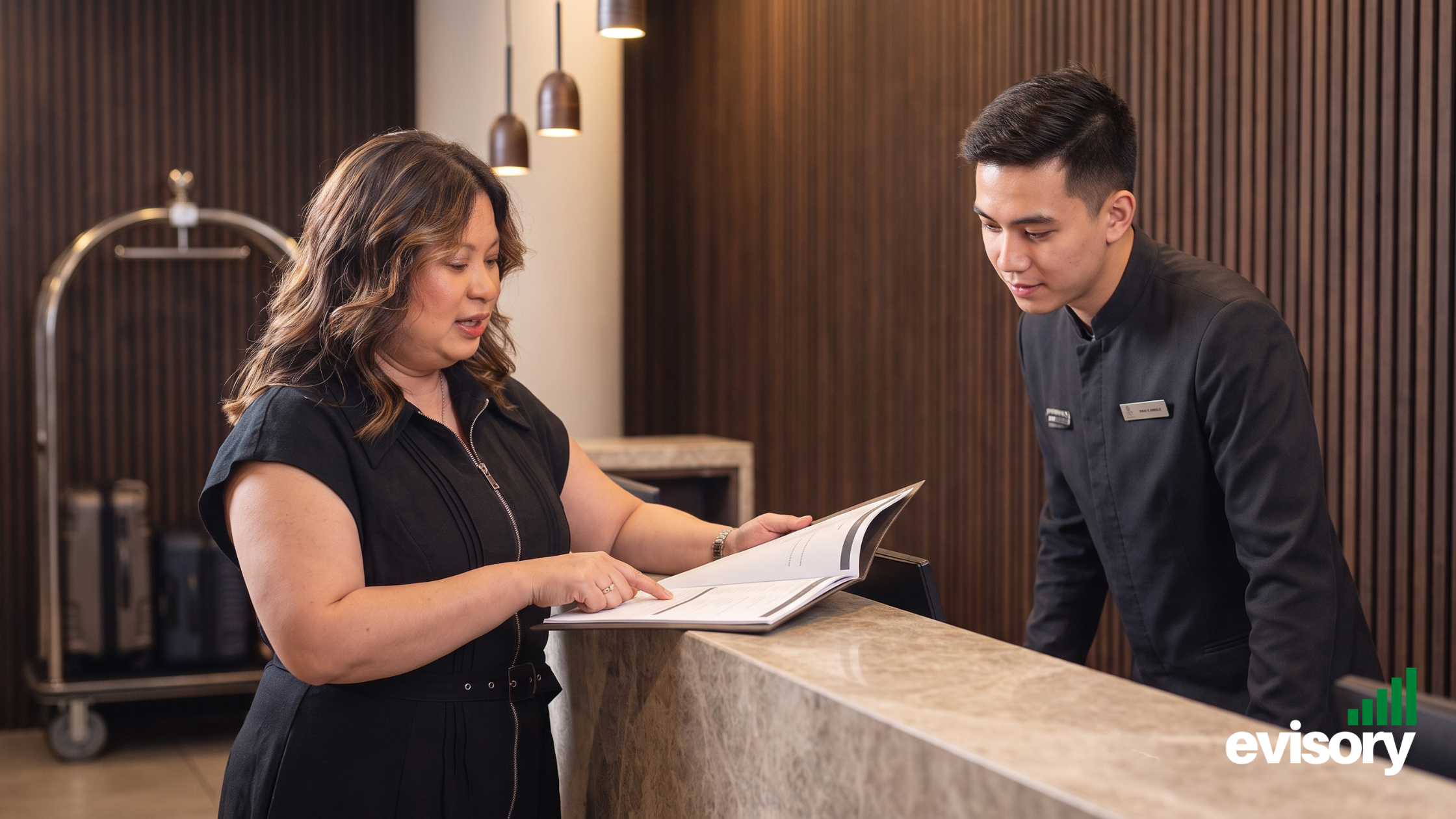 Linda Dang, Evisory CEO with a hotel staff discussing ATO Benchmarks
