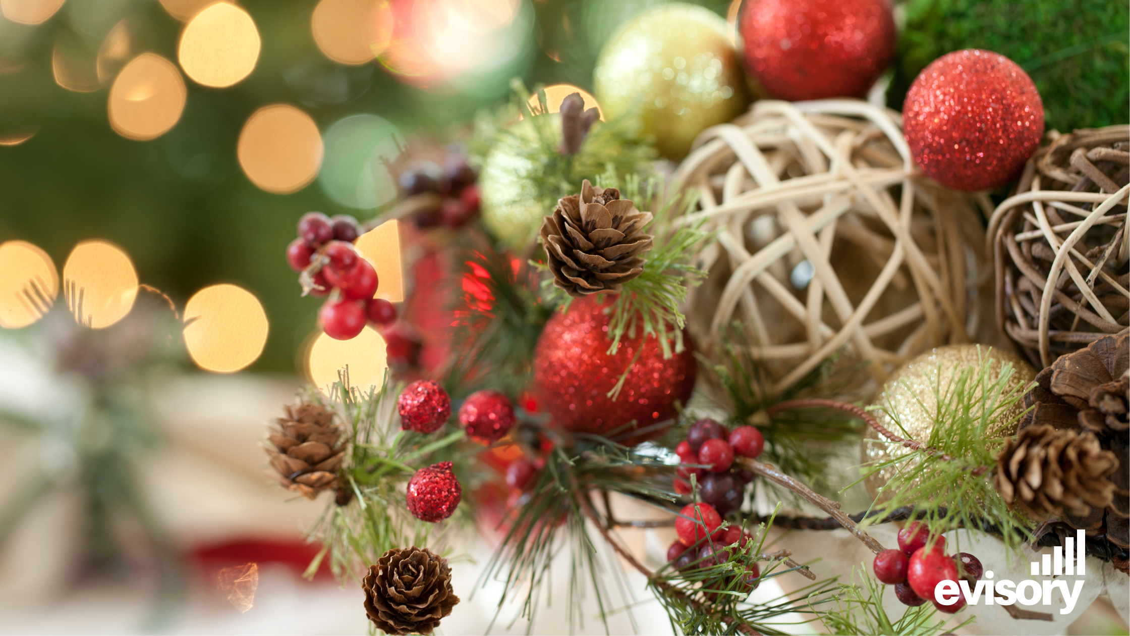 Festive holiday decorations and ornaments with soft bokeh lighting and the Evisory logo.