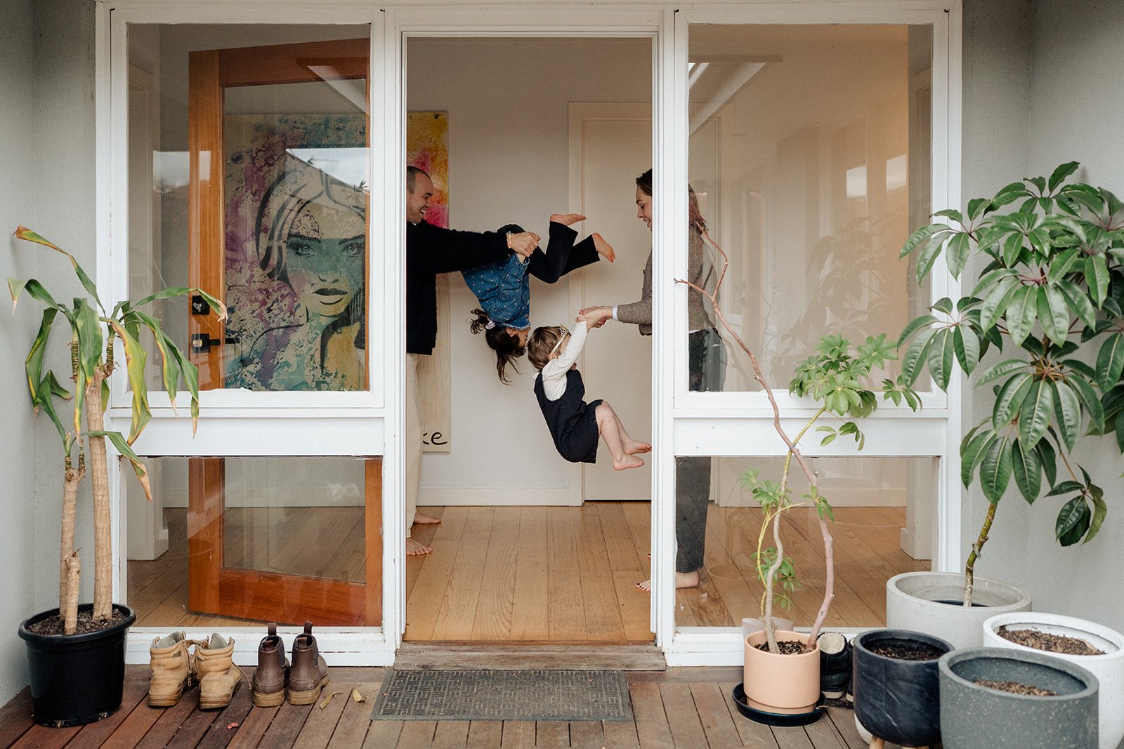 A happy family running around their house. Taken during an in-home family photography session in Melbourne. 