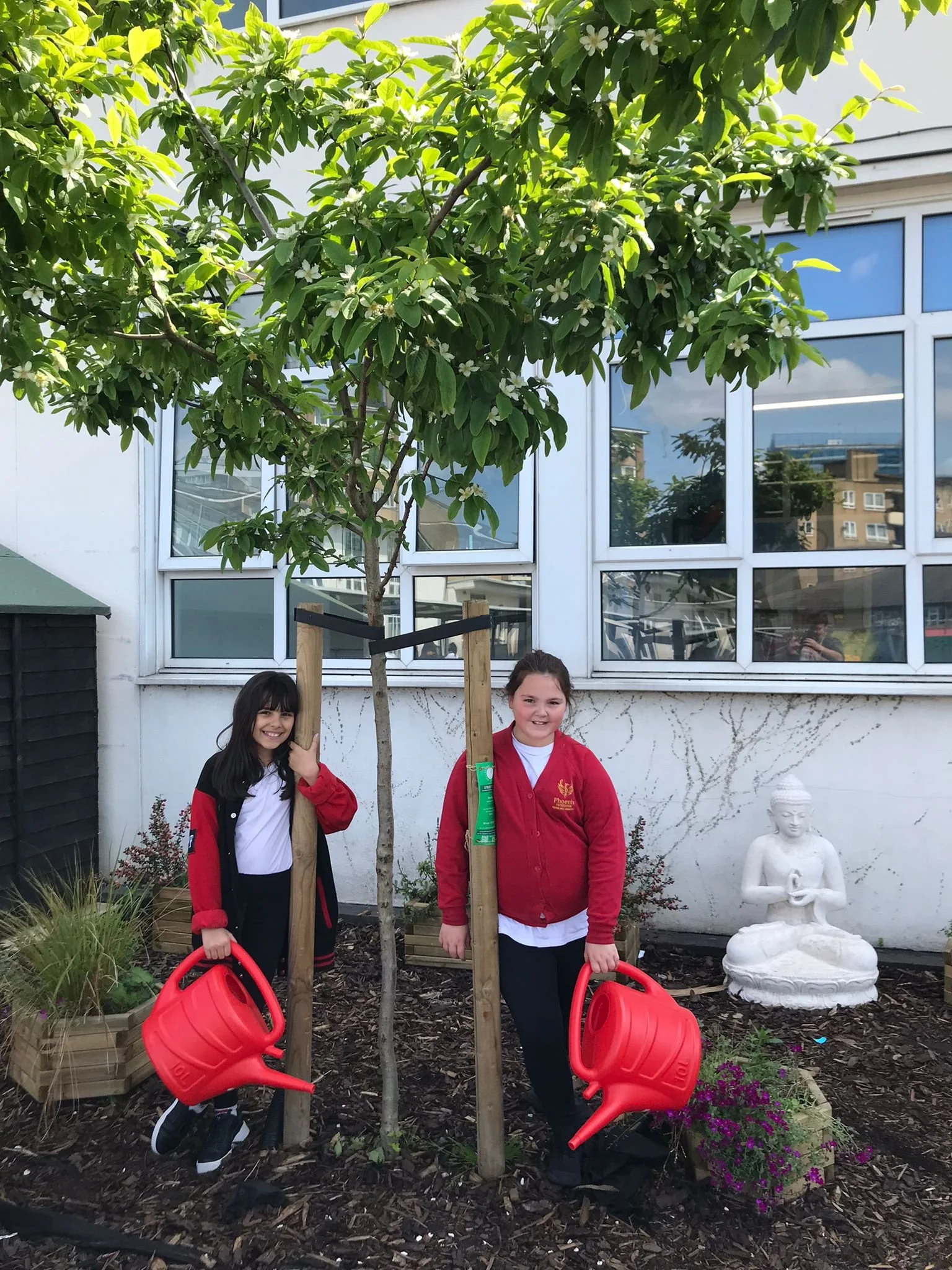Two girls posing next to tree.jpg