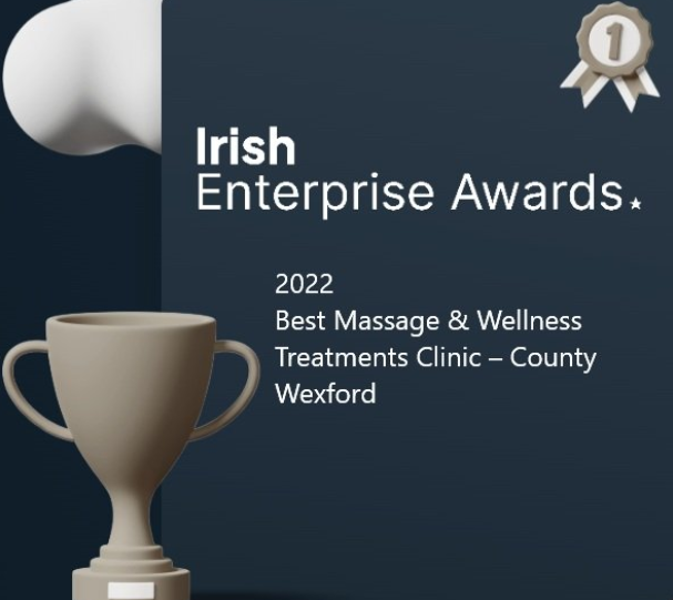 Irish Enterprise Awards 2022, recognizing Best Massage & Wellness Treatments Clinic in County Wexford, featuring a trophy and award ribbon.