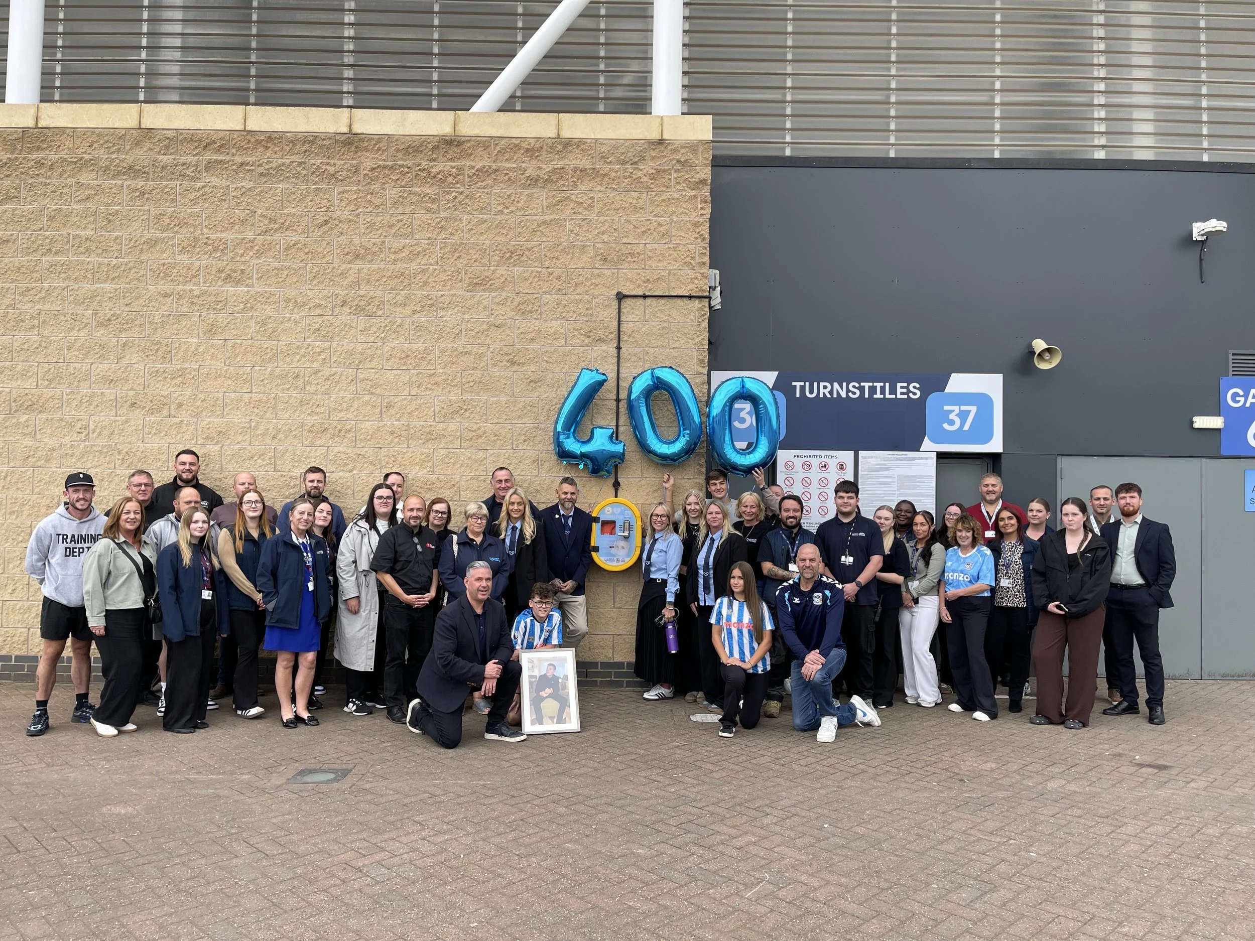 Life-saving defibrillators installed at Coventry Building Society Arena mark 400th for local charity