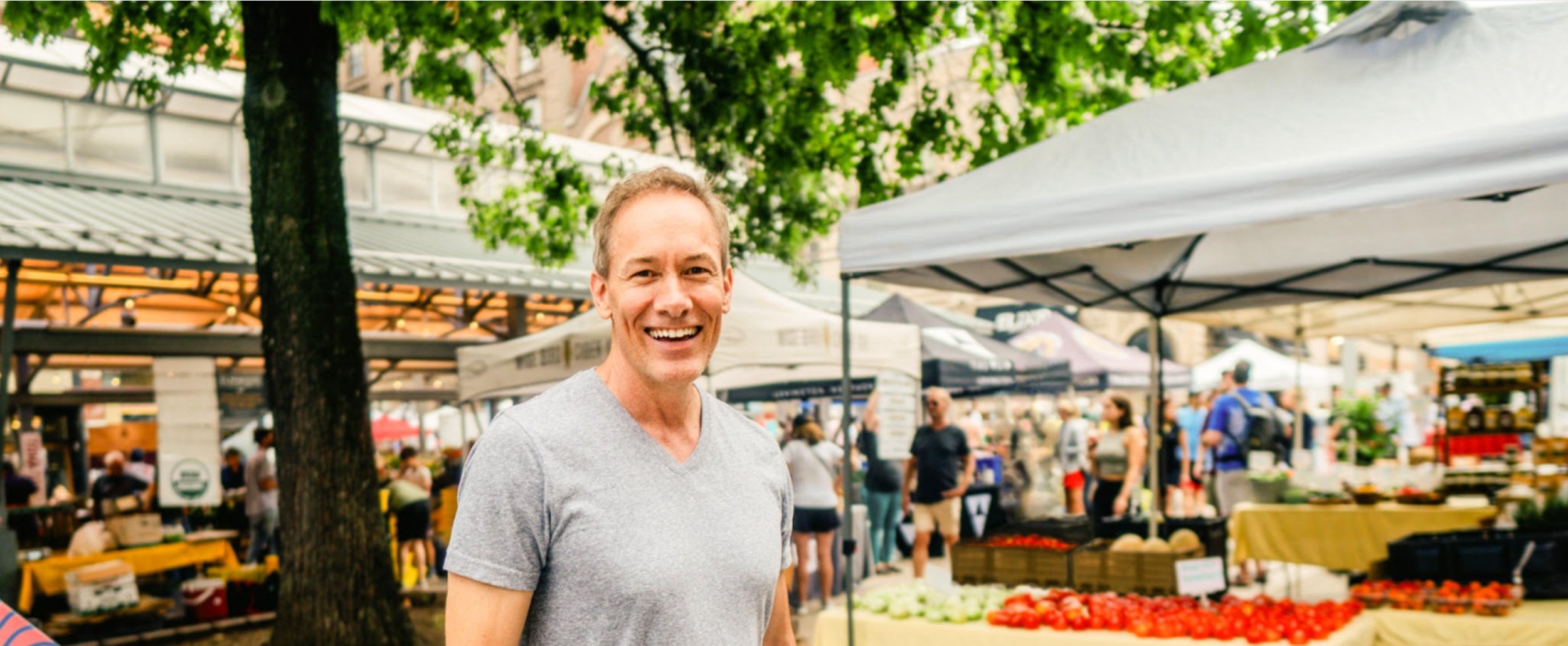 Trainer Joe smiling and standing in front of a local farmer's market in Lexington, Kentucky.