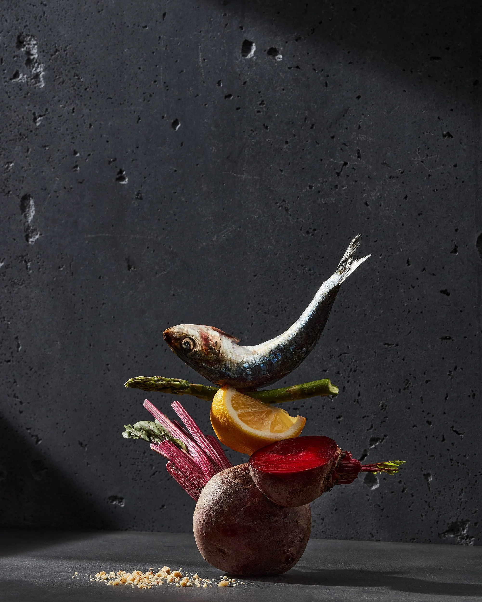 Omega3 rich food in their original form, beetroot, lemon, asparagus, and mackerel, all balancing on top of each other - photographed by Yunhee Kim - food styling, commercial food stylist NYC