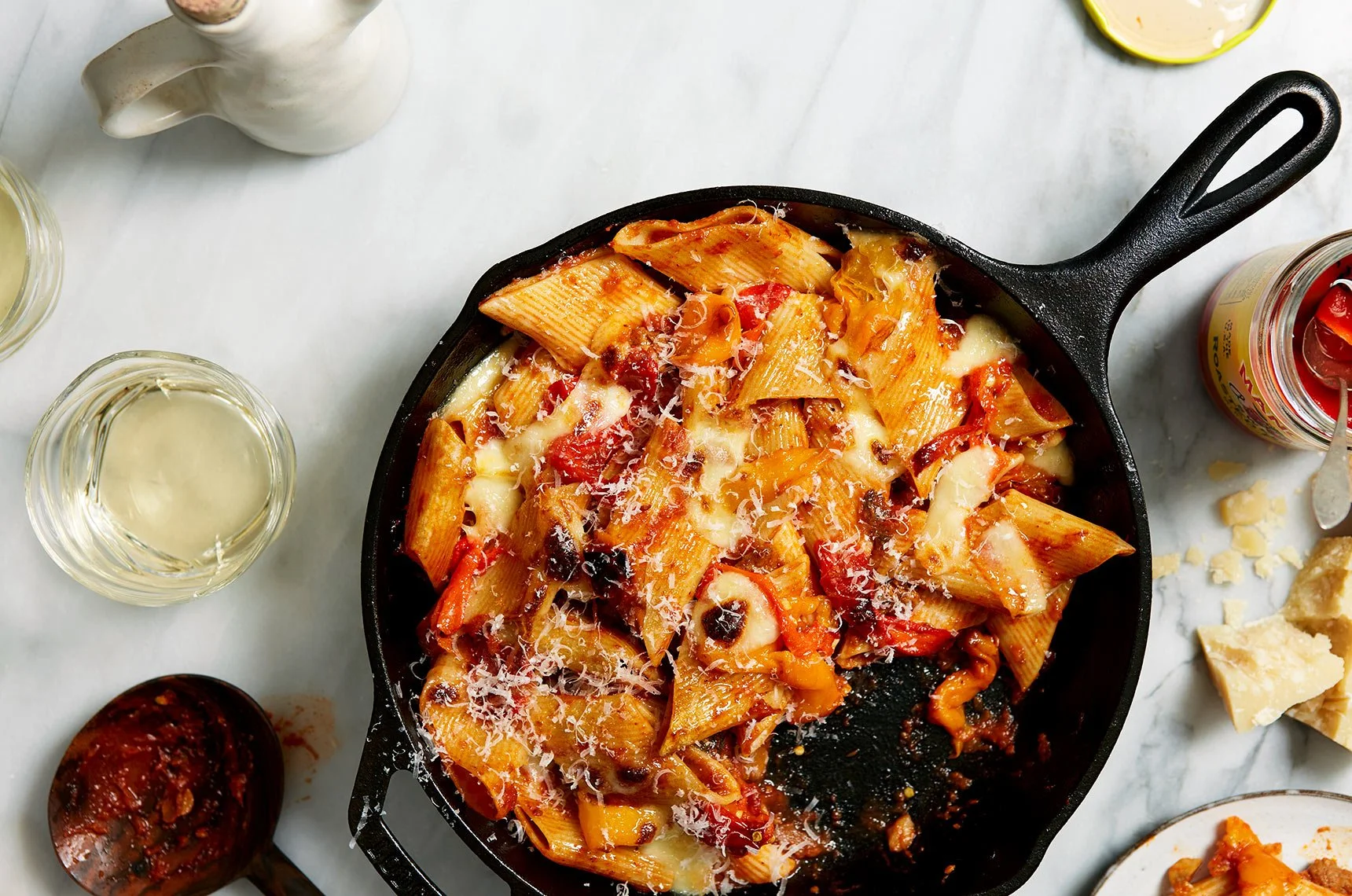 A surface of skillet baked pasta with peppers and mozzarella with wine and cheese - for a test concept shoot and photographed by Dane Tashima - food styling, commercial food stylist NYC
